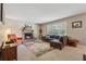 Inviting living room features stone fireplace, ample natural light, and stylish decor at 461 Village Green Sw Ct, Lilburn, GA 30047