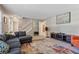 Living room view with access to a staircase, large windows and comfortable seating at 461 Village Green Sw Ct, Lilburn, GA 30047