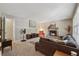 Cozy living room with a stone fireplace, neutral paint, and comfortable furniture at 461 Village Green Sw Ct, Lilburn, GA 30047