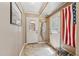 Bright mud room with tile floors, coat rack, US Flag and multiple doors leading to other rooms at 461 Village Green Sw Ct, Lilburn, GA 30047