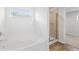 Clean and bright bathroom featuring a separate tub and shower with wood-look flooring at 7205 Brushwood Bend (Lot 31), Lithonia, GA 30058