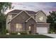 Charming two-story brick home featuring a manicured lawn and attached two-car garage at 7205 Brushwood Bend (Lot 31), Lithonia, GA 30058