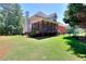 Backyard view with covered porch, lush lawn, established landscaping, and privacy fence, perfect for outdoor enjoyment at 781 Templeton Dr, Loganville, GA 30052
