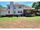 Spacious backyard with screened porch, lush lawn, and mature trees offers an outdoor retreat at 781 Templeton Dr, Loganville, GA 30052