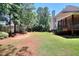 Expansive backyard featuring lush lawn, mature trees, and partial privacy fence for serene outdoor living and recreation at 781 Templeton Dr, Loganville, GA 30052