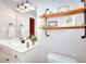 Stylish bathroom with floating shelves, modern fixtures, and bright vanity at 781 Templeton Dr, Loganville, GA 30052