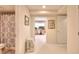 Bathroom with patterned shower curtain leading to office area at 781 Templeton Dr, Loganville, GA 30052