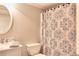 Neutral bathroom featuring a vanity, toilet, decorative shower curtain, and lighting fixture for a classic design at 781 Templeton Dr, Loganville, GA 30052