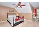 Well-lit bedroom featuring a red throw, a desk with a chair, and a ceiling fan at 781 Templeton Dr, Loganville, GA 30052