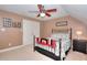 Cozy bedroom with a ceiling fan, neutral walls, and a metal frame bed accented with a colorful blanket at 781 Templeton Dr, Loganville, GA 30052