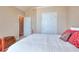 Comfortable bedroom showcasing white bedding, a red bed frame, and a unique side table at 781 Templeton Dr, Loganville, GA 30052