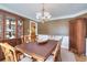 Dining room with wood floors, china cabinet, wainscoting, and decorative light fixture at 781 Templeton Dr, Loganville, GA 30052