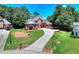 Front exterior of a well-manicured house with brick, lush lawn, and long driveway in a desirable neighborhood at 781 Templeton Dr, Loganville, GA 30052
