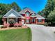 Charming brick home with well-manicured lawn, long driveway, and lush landscaping at 781 Templeton Dr, Loganville, GA 30052