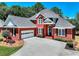 Beautiful brick home with attached garage, manicured bushes, and concrete driveway at 781 Templeton Dr, Loganville, GA 30052