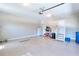 Clean, well-lit garage with epoxy flooring, ample space, and convenient access door for parking and storage at 781 Templeton Dr, Loganville, GA 30052
