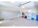 Clean, well-lit two car garage featuring epoxy flooring, storage and a side entrance at 781 Templeton Dr, Loganville, GA 30052