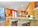 Bright kitchen with wood cabinets, granite countertops, and a breakfast bar with seating at 781 Templeton Dr, Loganville, GA 30052