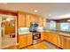 Kitchen features wood cabinets, stainless steel appliances, and granite countertops at 781 Templeton Dr, Loganville, GA 30052