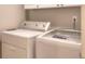 A utility room features a front loading washer and dryer at 781 Templeton Dr, Loganville, GA 30052