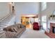 Cozy living room with fireplace, staircase, and a view of the kitchen at 781 Templeton Dr, Loganville, GA 30052