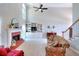 Cozy living room featuring a fireplace, built-in shelving, and a staircase at 781 Templeton Dr, Loganville, GA 30052