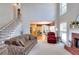 Bright living room with fireplace, large windows, and open staircase provides ample natural light at 781 Templeton Dr, Loganville, GA 30052