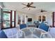 Relaxing screened patio with ceiling fans, cozy seating, and wooded views at 781 Templeton Dr, Loganville, GA 30052