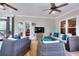 The screened patio includes comfortable furniture with blue cushions, a television, and ceiling fans at 781 Templeton Dr, Loganville, GA 30052