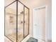 This bathroom has a tile shower with a glass enclosure and bench seating near a closed door at 781 Templeton Dr, Loganville, GA 30052