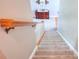 Carpeted stairway leading to an upper level, complemented by a wooden handrail and neutral wall colors at 781 Templeton Dr, Loganville, GA 30052