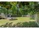 Well-maintained backyard featuring a trampoline, shed, and fenced perimeter at 161 N Barton St, Norcross, GA 30071