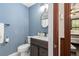Cozy bathroom with stylish vanity, dark wood accents, and blue walls at 161 N Barton St, Norcross, GA 30071