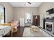 Charming bedroom features a fireplace, hardwood floors, and bright natural light at 161 N Barton St, Norcross, GA 30071