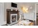 Bright bedroom features a fireplace, white dresser, and dark hardwood floors at 161 N Barton St, Norcross, GA 30071