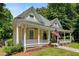 Charming yellow two-story home with an inviting front porch, mature trees, and well-manicured lawn at 161 N Barton St, Norcross, GA 30071