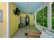 The front porch features a tv, porch swing, and inviting setup for enjoying outdoor living at 161 N Barton St, Norcross, GA 30071