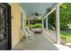 Inviting front porch features a porch swing, rocking chairs, and a cozy atmosphere for relaxation at 161 N Barton St, Norcross, GA 30071