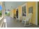 Inviting front porch features rocking chairs, an American flag, and a welcome sign for guests at 161 N Barton St, Norcross, GA 30071