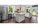 Bright kitchen with stainless steel appliances, a center island, and dark hardwood floors at 161 N Barton St, Norcross, GA 30071