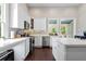 Bright kitchen features stainless steel appliances, an island, and white cabinetry at 161 N Barton St, Norcross, GA 30071