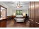 Bedroom with hardwood floors, wooden trim, a ceiling fan, and a large window overlooking the yard at 161 N Barton St, Norcross, GA 30071