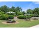 Community park featuring picnic tables with umbrellas surrounded by lush greenery at 161 N Barton St, Norcross, GA 30071