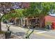 Charming street view of local shops with artistic flower arrangements and landscaping at 161 N Barton St, Norcross, GA 30071