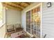 Cozy balcony features a seating area with wicker chairs, sliding glass door, and natural light at 215 Cobblestone Trl, Avondale Estates, GA 30002