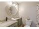 Bathroom with granite vanity, decorative mirror and lighting, and patterned shower curtain at 215 Cobblestone Trl, Avondale Estates, GA 30002