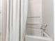 Bathtub with white curtains, a white interior and silver fixtures at 215 Cobblestone Trl, Avondale Estates, GA 30002