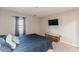 Bedroom with blue quilt, window with gray curtains, and wall-mounted television at 215 Cobblestone Trl, Avondale Estates, GA 30002