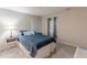 Cozy bedroom with window with gray curtains, side tables, and a comfortable quilt at 215 Cobblestone Trl, Avondale Estates, GA 30002
