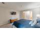 Bright bedroom featuring a large bed, a TV and a wooden storage chest at 215 Cobblestone Trl, Avondale Estates, GA 30002